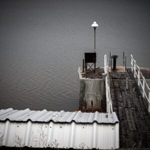 Wooden dock with damaged and missing deck boards